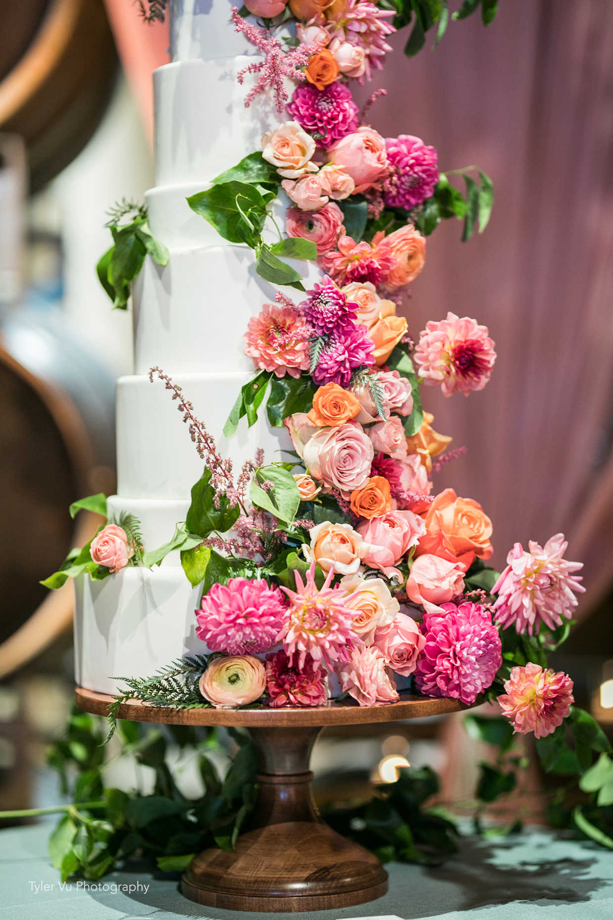 Beautiful dahlia and rose waterfall wedding cake at Casa Real at Ruby Hill Winery (www.casarealevents.com).  Photo by: Tyler Vu Photography; Florals: Enchantment Floral; Cake: Ma Petite Maison 