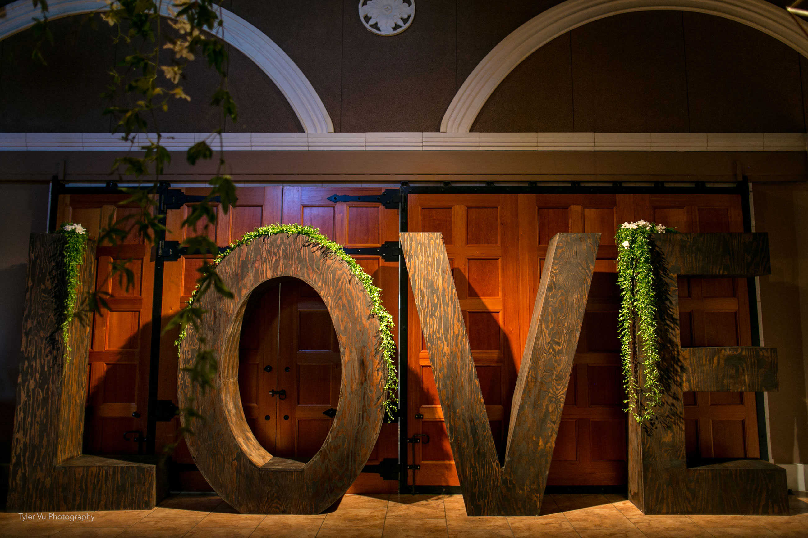 Rustic life-size LOVE letters at Casa Real at Ruby Hill Winery (www.casarealevents.com).  Photo by: Tyler Vu Photography.  Letters from Fantasy Sound Event Services